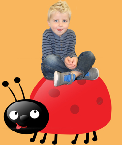 a Vista Kids Preschool child sitting on a ladybug
